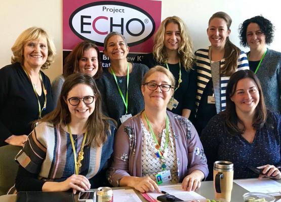 A group of woman in front of a sign that says Project ECHO