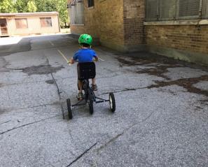Child pedalling on his bike.
