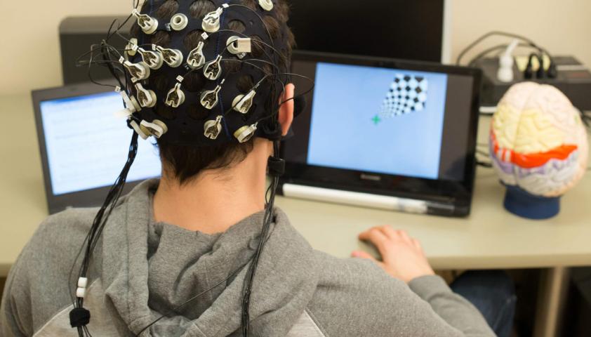 Person wearing EEG brain-computer interface device