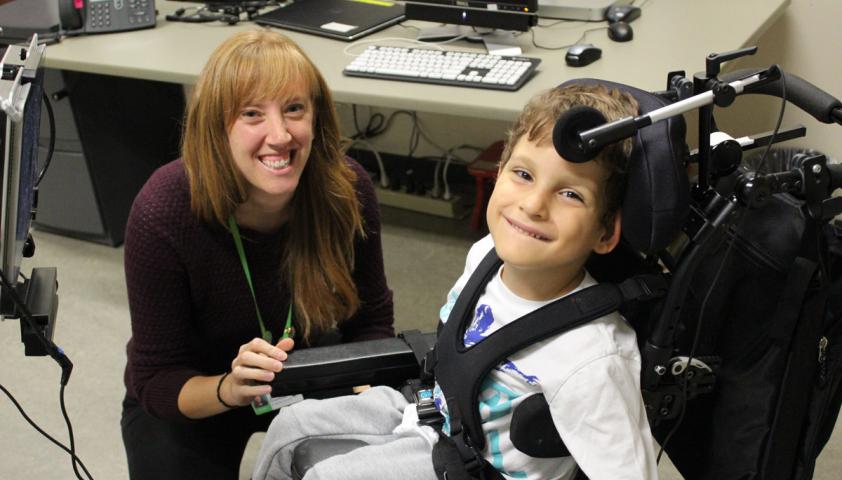 Staff with boy in wheelchair