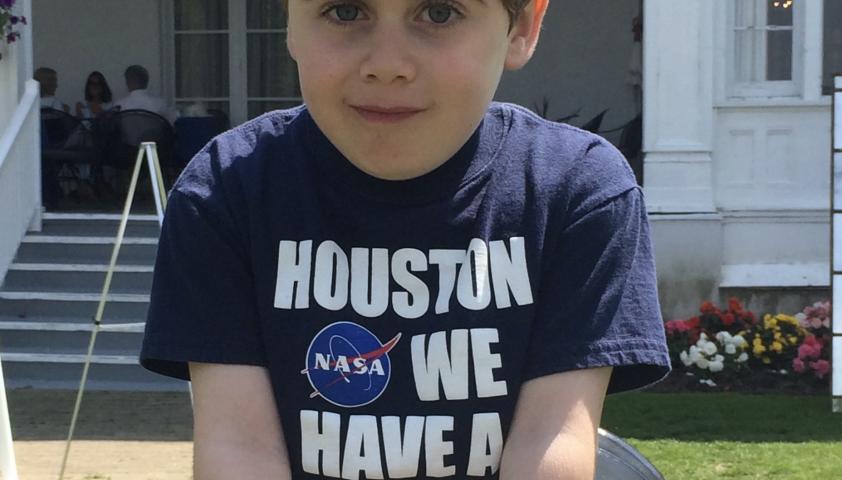 Emery sitting down, wearing a NASA shirt