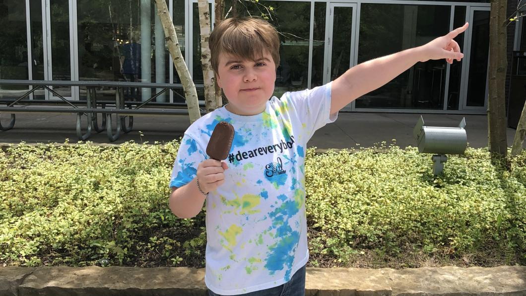 Emery in a #DearEverybody shirt with a popsicle