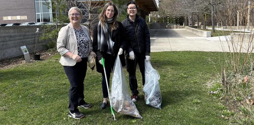 Some people picking up garbage from the glass.