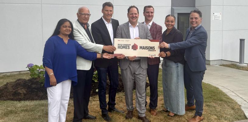 group of adults holding a sign during an announcement