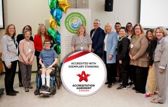 A group of people with the Accreditation Canada badge