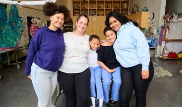 Family with staff standing in a workshop