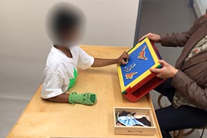 Grab magnetic toys off of magnetic board and drop into a container 