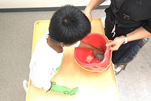 Grab toys floating in a water bin.