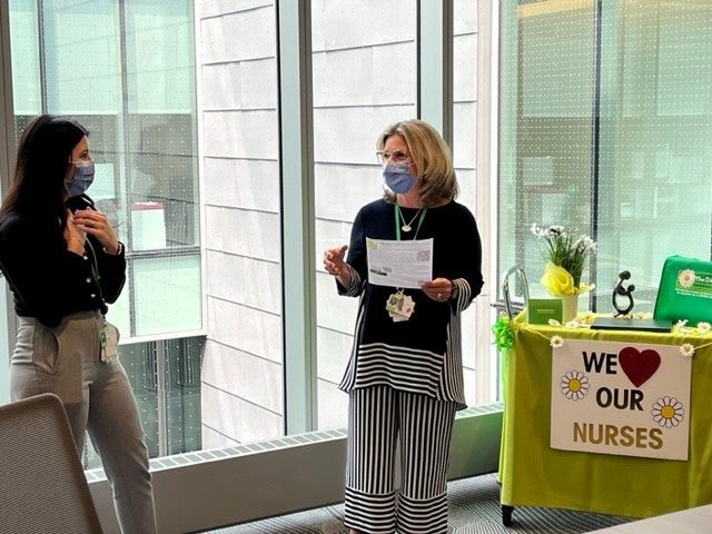 Irene Andress, vice president, programs and services, chief nursing executive, presenting the DAISY Award to Emilie Canham