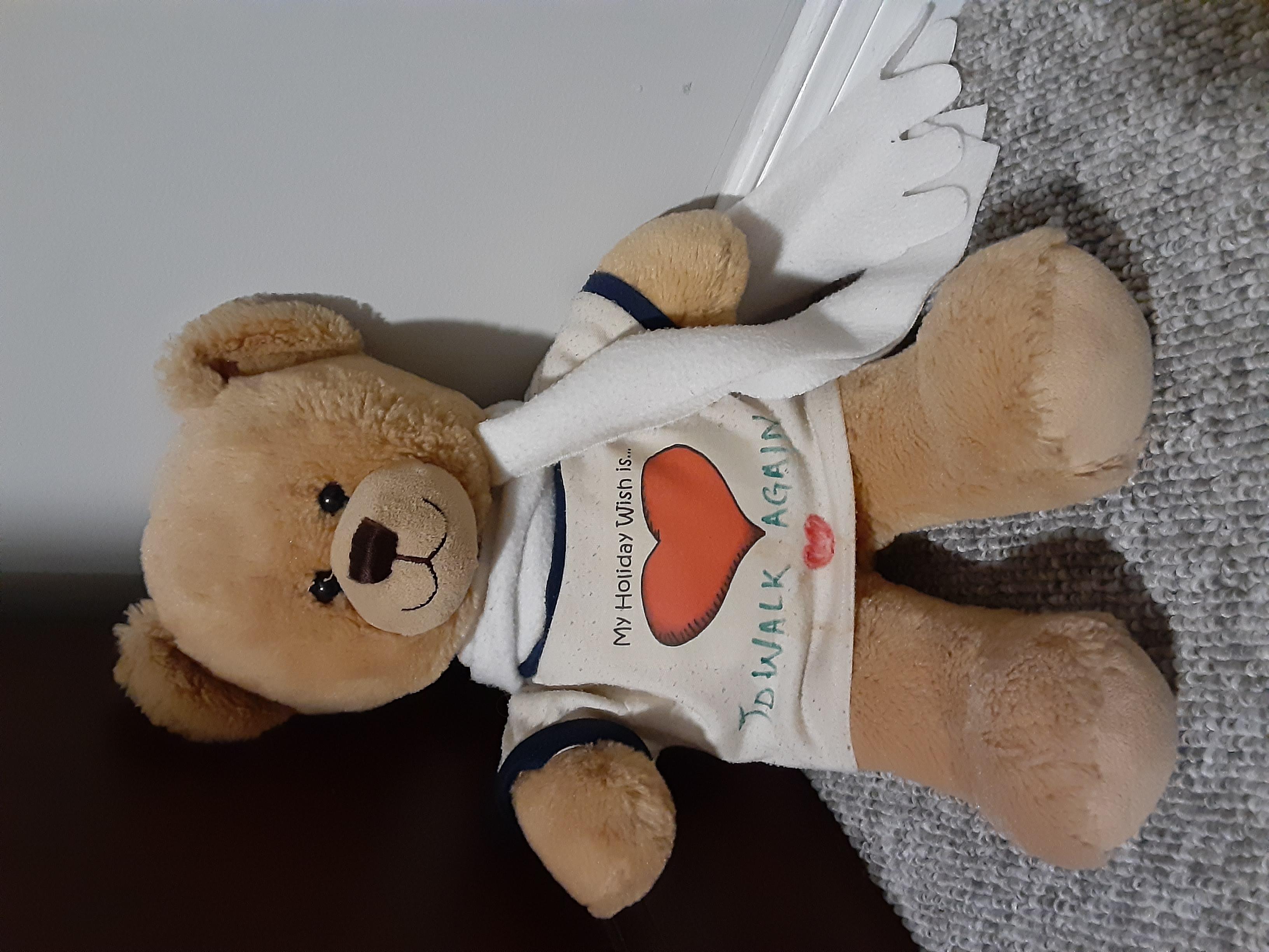 A teddy bear wears a white t-shirt with a heart on it