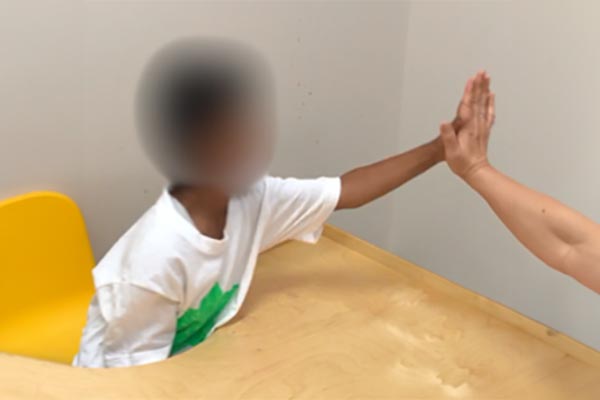 Give high-5’s (elbow straight), play hand games (e.g., pat a cake) far enough away to have a straight elbow. 