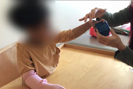 Place toys that do not change shape or bend, such as a block, in infant's hand.