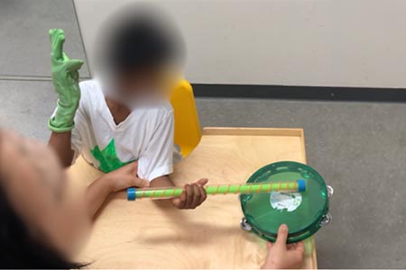 Have infant hold drumstick and hold a hand drum to the outside of the helper hand side. Encourage infant to rotate forearm with palm up to hit drum. Can use household items (spoon and pot).