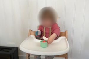 Pour toys out of a container into a bin placed on the backside (knuckles) of the infant's hand