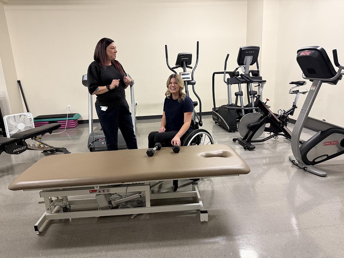 Two people demonstrating to use some gym equipment