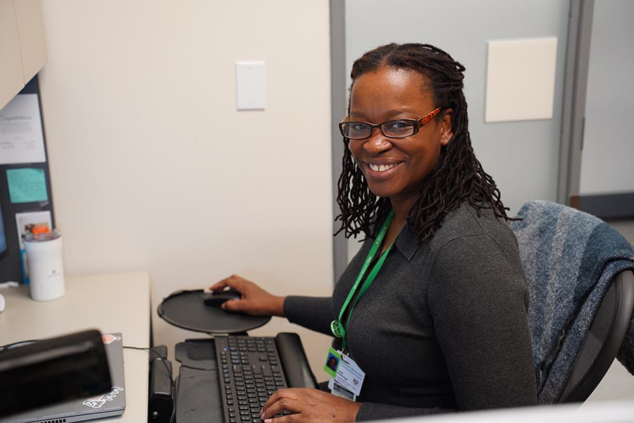 An adult working at her desk