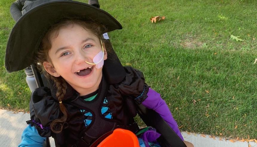 A child in a wheelchair outside
