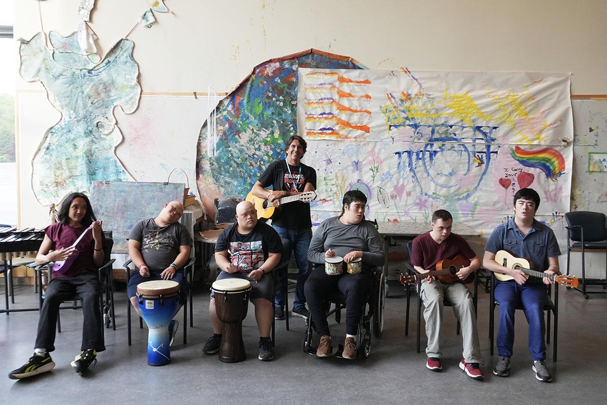 HB Rocks co-founder Garson Hoffman joins one of the bands for a group photo ahead of rehearsal.