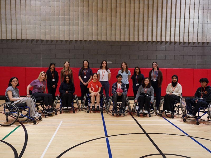 Gabriela (second from left, in purple) with fellow Ward Summer Students and program staff following a wheelchair basketball activity at Holland Bloorview.