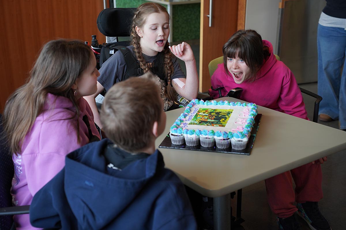The girls celebrate Finnley’s (pictured centre) discharge from Holland Bloorview after a 10‑month inpatient stay.