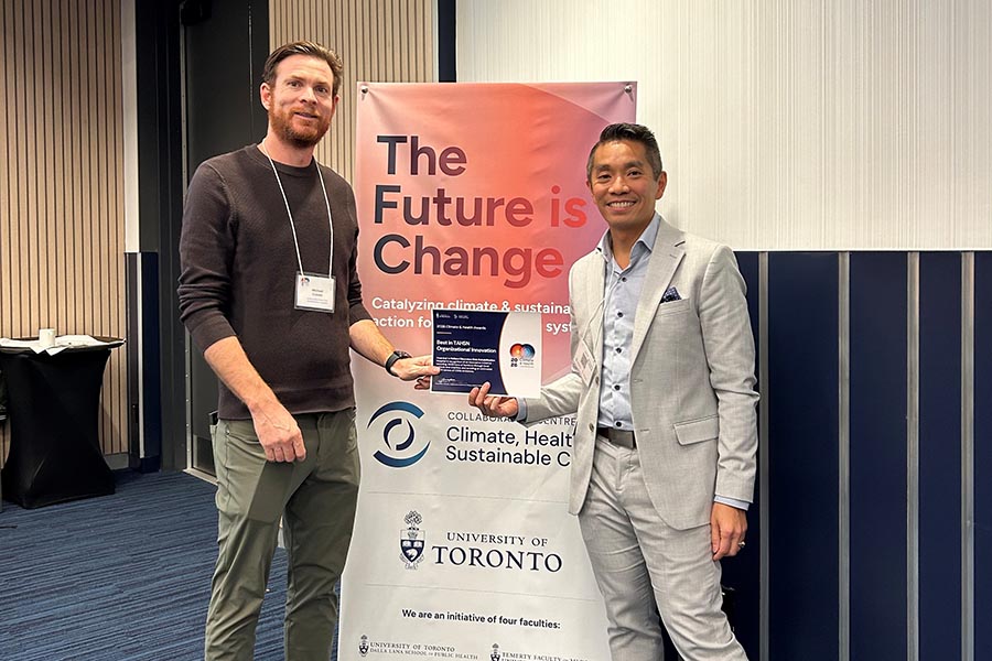 Director of facilities management Michael Craven (left) and VP of communications, strategy and sustainability Stewart Wong (right) celebrate Holland Bloorview’s TAHSN award win at the 2026 Climate and Health Conference.