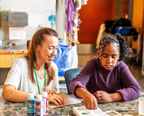 An adult and a child within an indoor setting