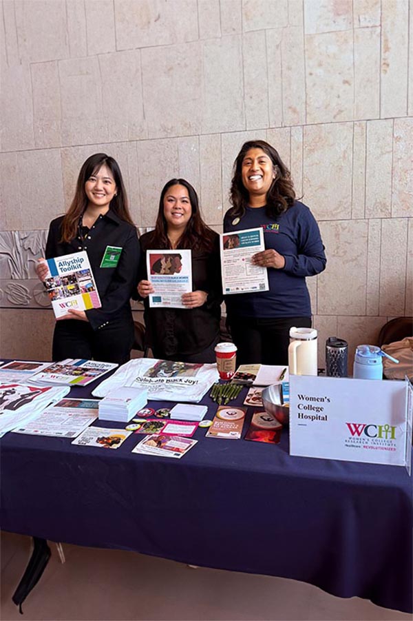 Three adults showing some documents in a booth