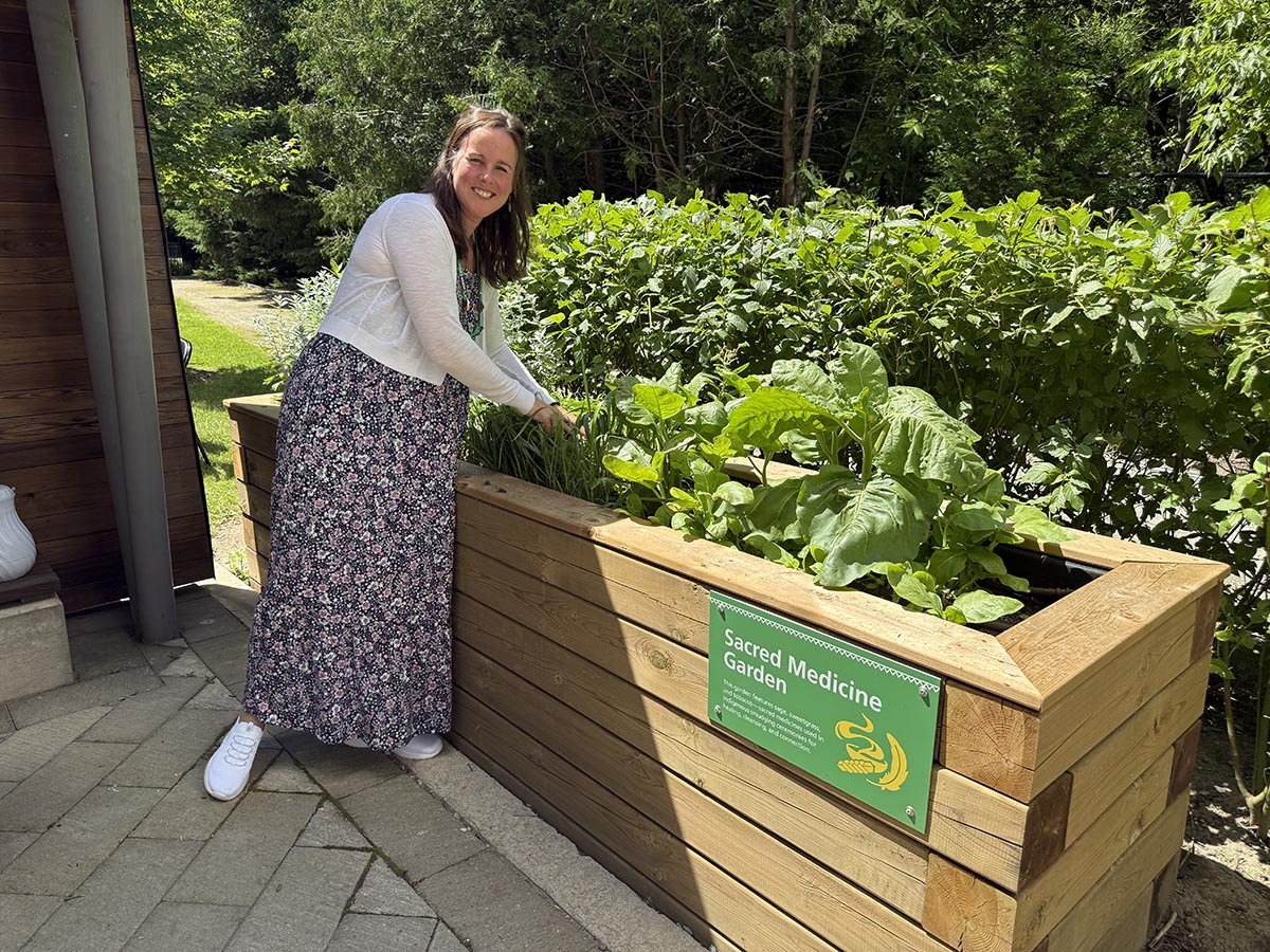 Anita gathers sweetgrass from the Holland Bloorview’s Sacred Medicine Garden