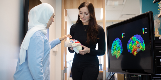 Researchers discussing brain scans