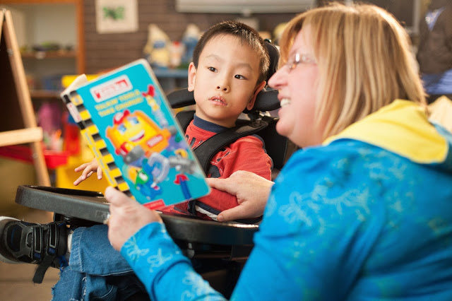 Debbie reading to a student