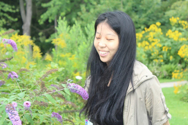 Lexin smiling near some flowers