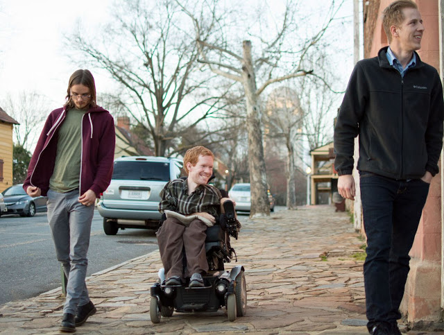 Kevan and friends walking along a street