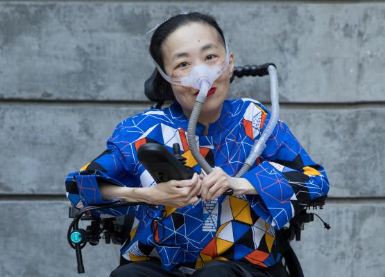 Photo of an Asian American woman in a power chair