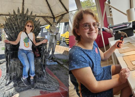Woman sitting in ancient chair with spikes and at a drawing board holding a hammer