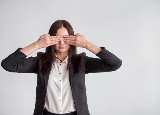 Woman puts hands over eyes