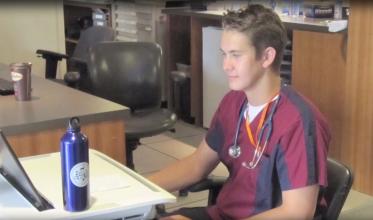 Male nurse sitting at a desk