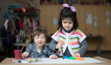 Two young girls painting. 