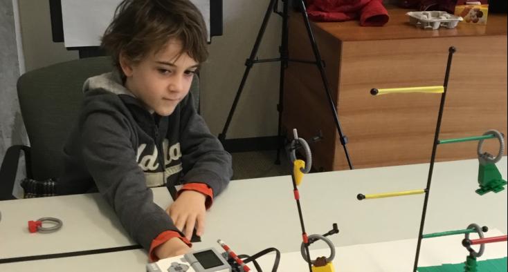 a boy is playing with robots