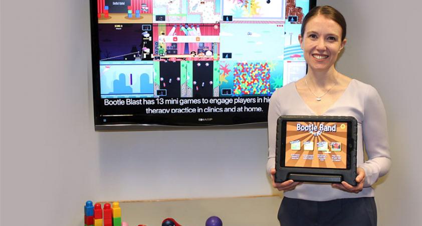 scientist holding a tablet with a game design