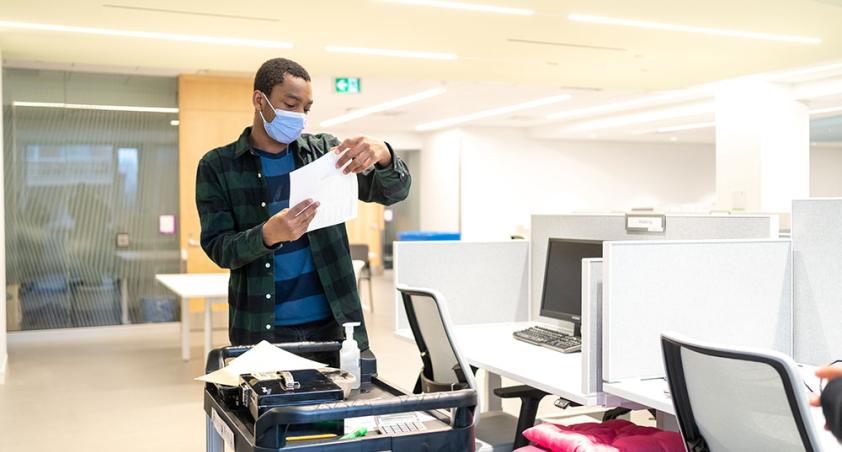 A staff with mask on working in a hospital setting