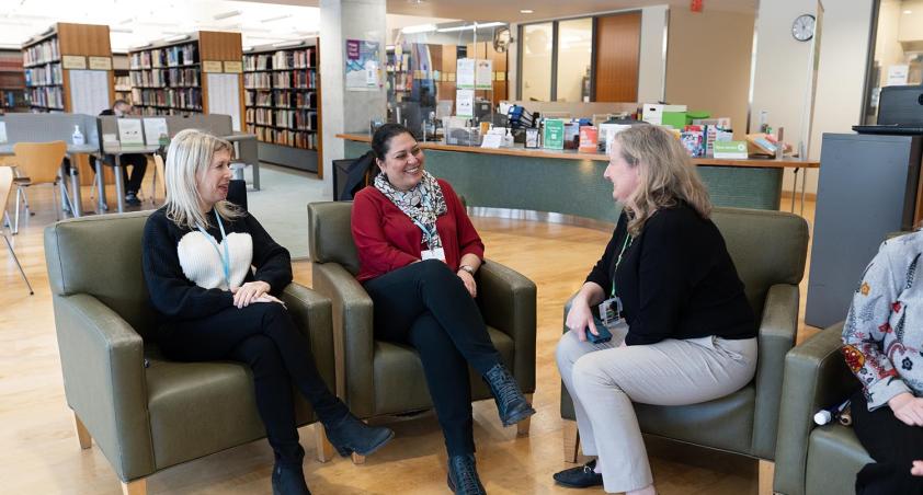 A meeting is holding in a library setting