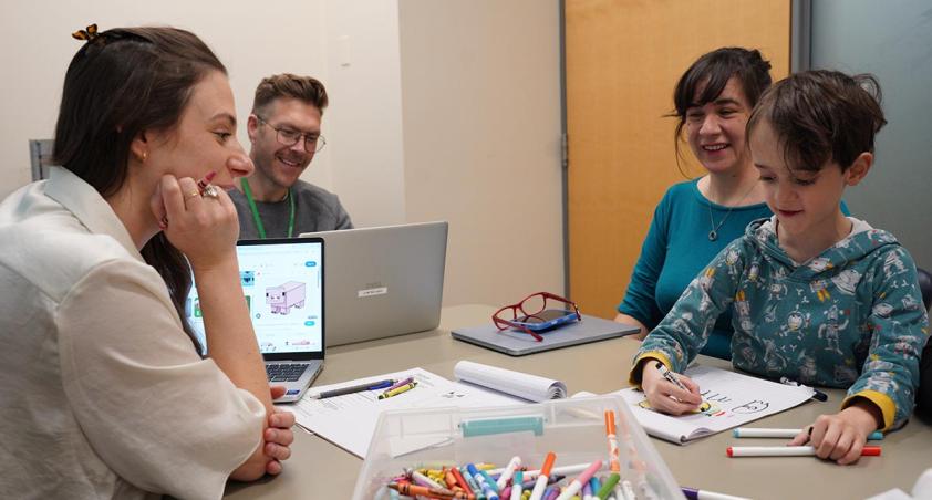 Three adults are interviewing with a child to assess him