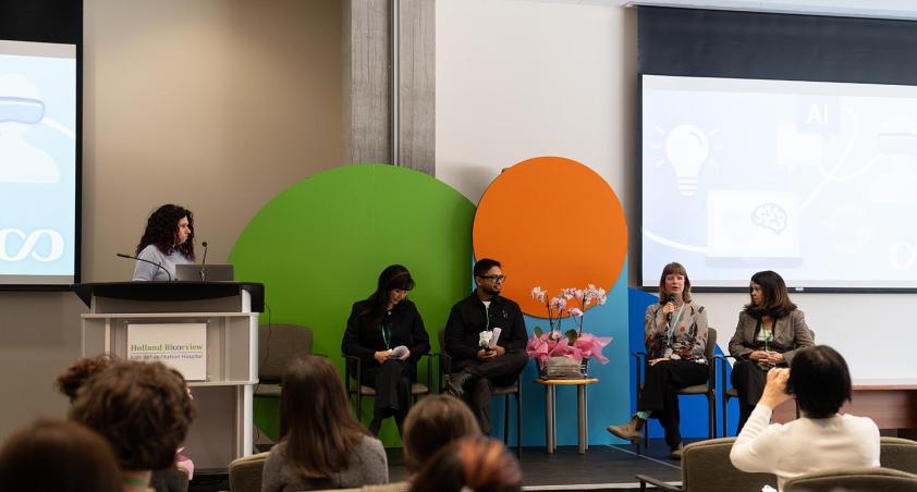 Some people on a stage in a conference