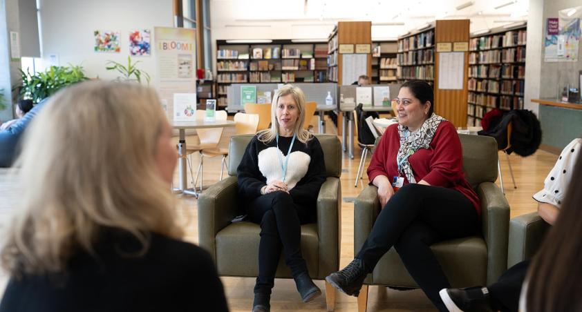 Some people having a meeting in a library