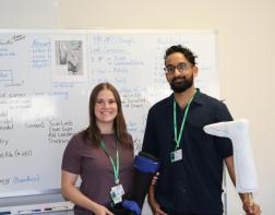 Staff smiling while holding a prosthetic mold