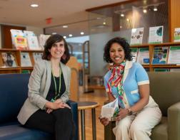 Family support specialists, Ishwarya and Stephanie, in the library