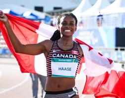 Sheriauna running with the Canadian flag