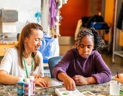 Client and staff painting in the art studio
