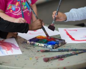 Close-up of kids painting. 