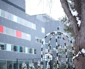 A wintery scene in Spiral Garden with the Holland Bloorview building in the background 